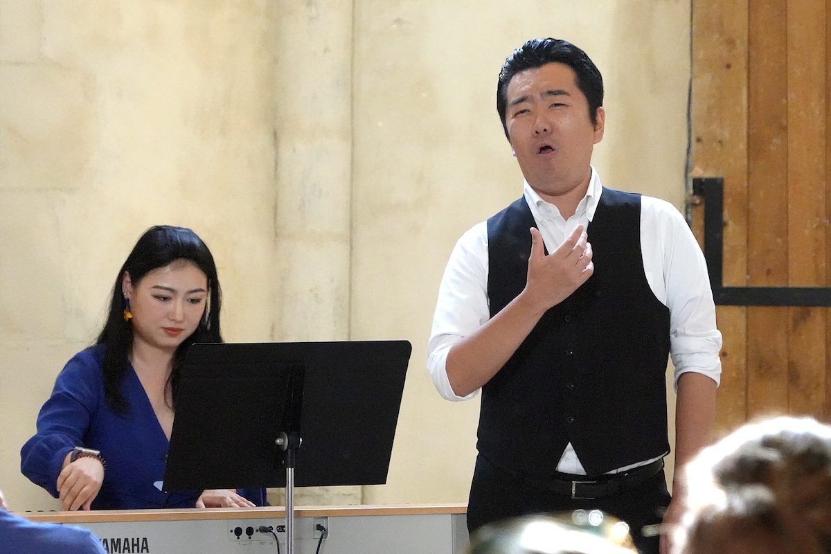 A singer performing with piano accompaniment
